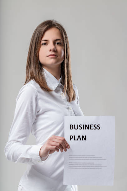 istock Business plan displayed, white shirt, brown-haired woman 1611420610