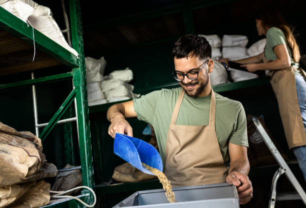 istock Male brewer grinding barley in brewery warehouse. 1611427600