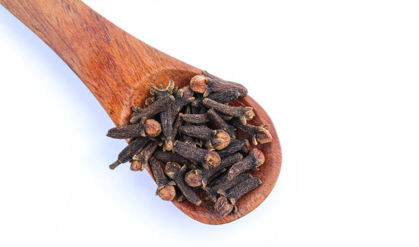 istock Dried Cloves in a wooden spoon top view 1611442625