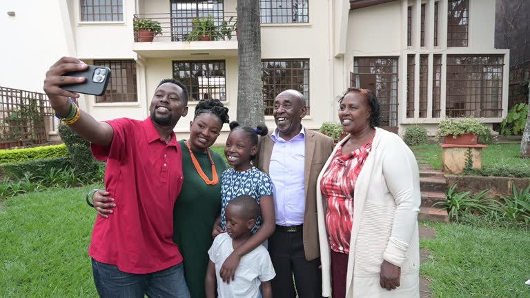 Black family posing for selfie in home garden