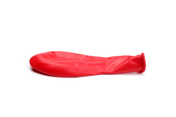 istock Unblown red balloon isolated on white 1611454909