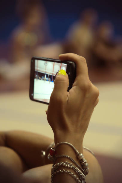 istock filming a rhythmic gymnastics competition with a mobile phone 1611470811