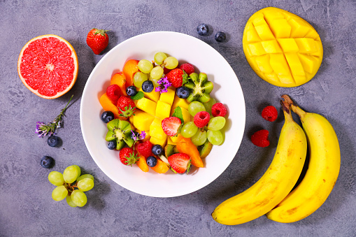 delicious fruit salad with mango, berry and banana- health food