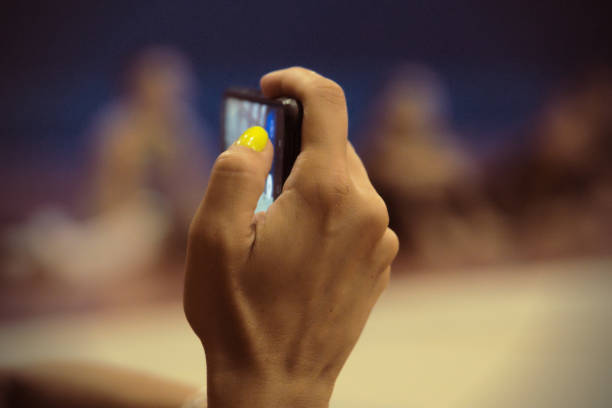 istock filming a rhythmic gymnastics competition with a mobile phone 1611470819