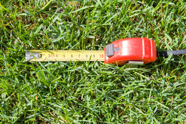 Tape measure on green grass, close-up of photo.