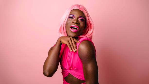 istock Confident Young Transgender Woman's Joyful Portrait on pink background 1611472949
