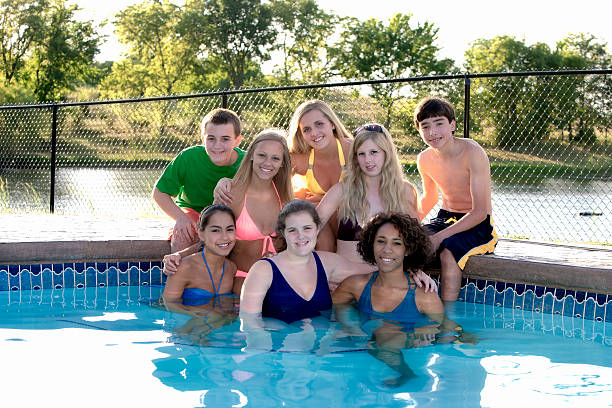 istock Group of Diverse  Teens Sitting in Swimming Pool 161149293