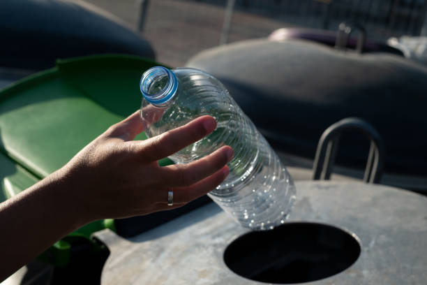istock A woman inserts plastic bottles into the recycling container 1611501060