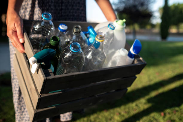 istock A woman carries recycling plastic bottles inside a box 1611501072