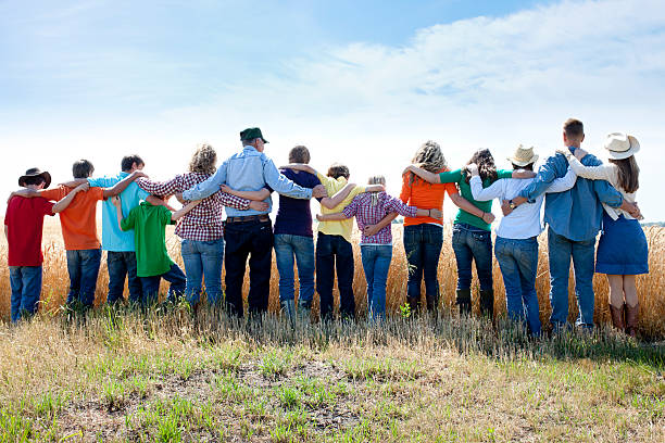 Christian Religious Family Group Prays to God Thankful Crop Farm A joyful family offers thanks to God for the success of their wheat crop on their farm. Represents faith, "down home" family values and an ethic of hardwork and love. arm around stock pictures, royalty-free photos & images