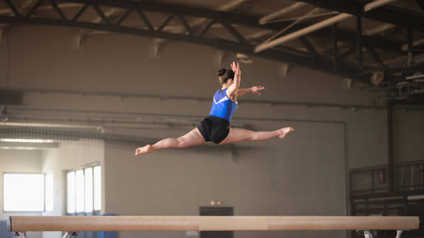 istock Female Gymnast On Balance Beam 1611506933