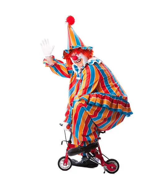 A full length image of an adult male clown riding a little bicycle and waving.http://www.janibrysonstudios.com/Banners/Clowns