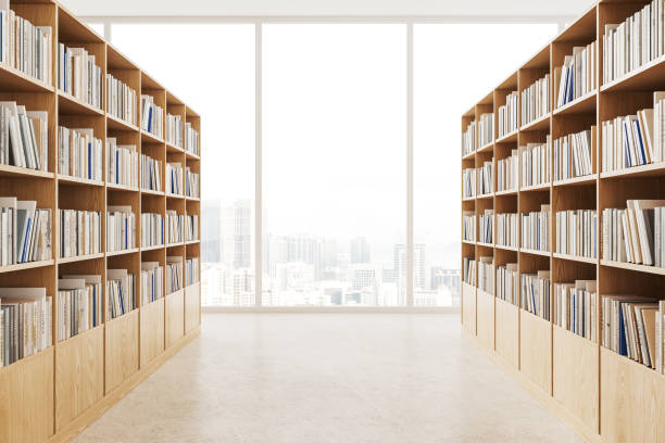 istock Two rows of bookcases in public library with panoramic window 1611526217