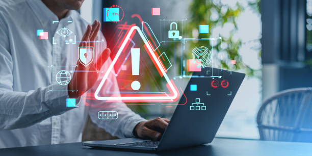istock Businessman using laptop with cyber security alert screen 1611526967