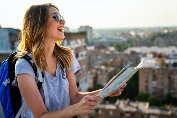 istock Young woman, student traveler with backpack enjoying summer vacation. 1611530035