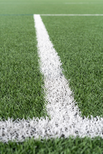 Close Up of white stripe on artificial turf soccer field with selective focus. High quality photo