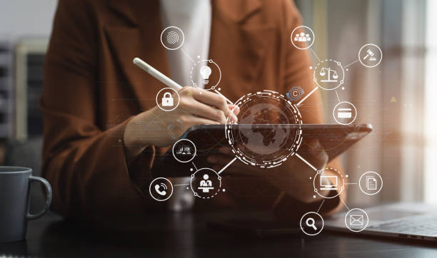 istock Copyright or patent concept, Person hand using laptop computer, tablet and smartphone with virtual screen copyright icon trademark, Creation ownership against piracy at office. 1611533868