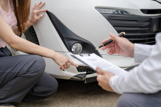 istock Insurance concept, insurance agent checking broken car and submit a claim form after an accident traffic accident 1611534424