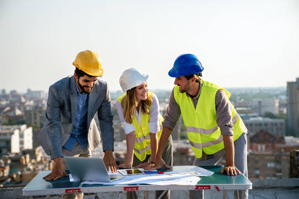 istock Business, teamwork and people concept. Group of engineers and architects on construction site 1611540454
