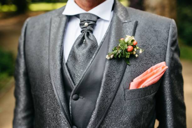 istock a man in a suit with his pink pocket square bouthole on 1611542040