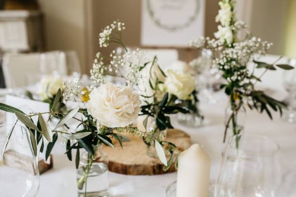 istock vases filled with flowers and greenery sit on a table 1611543660