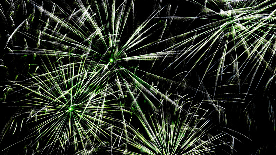 Bright fireworks background map in green color. Beautiful bright fireworks on a black background