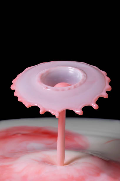 istock Red colored milk drop umbrella shaped collision splash 1611570687