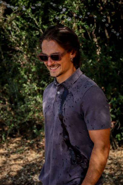 istock Young man soaked at the park 1611621337