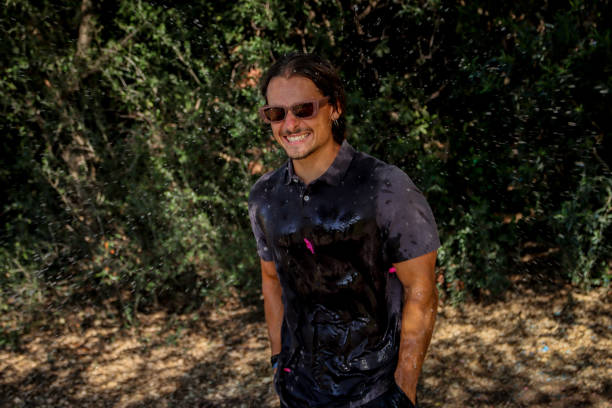 istock Young man soaked at the park 1611621349