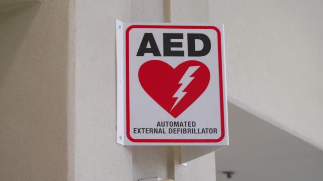 Life-Saving Device: Defibrillator Sign on Wall in 4k slow motion 60fps