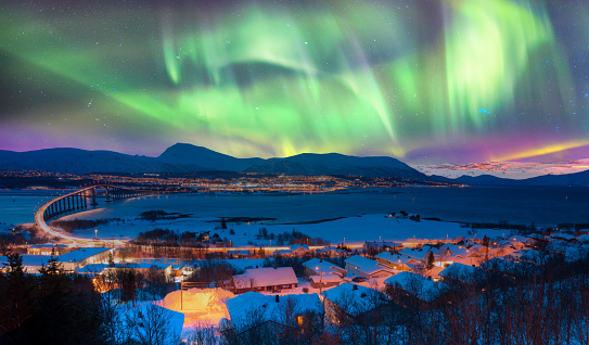 Aurora borealis or Northern lights in the sky over Tromso with Sandnessundet Bridge - Tromso, Norway