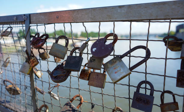 istock Love padlocks. Padlocks connected to the fence on the bridge. 1611647892