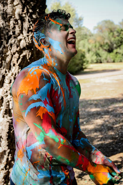 istock Young men playing in a paint fight 1611658545