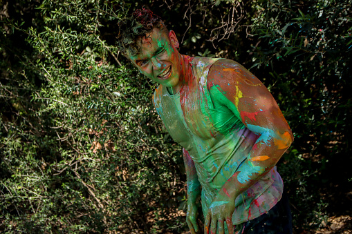 Young man laughling after get covered in paint