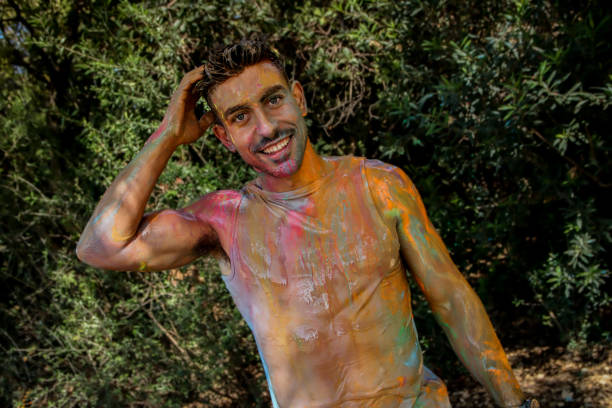istock Young men playing in a paint fight 1611659266