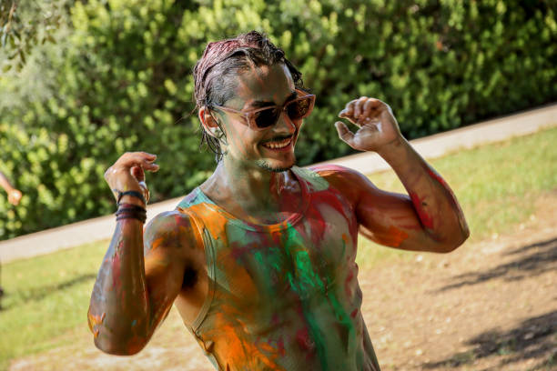 istock Young men playing in a paint fight 1611659631