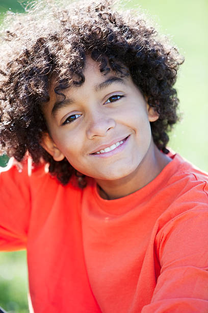 istock Real People: Mixed Race Boy Sitting in Park Closeup Headshot 161167371