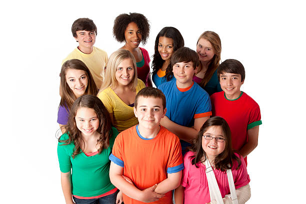 Diversity: Group of Multi-Racial Teenagers Friends Teamwork A high angle view of a multi-racial group of teenage girls and boys in colorful clothing standing together as a team. teenagers only stock pictures, royalty-free photos & images