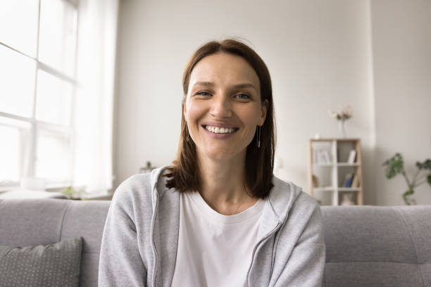 istock Cheerful pretty young woman talking on video call 1611703930