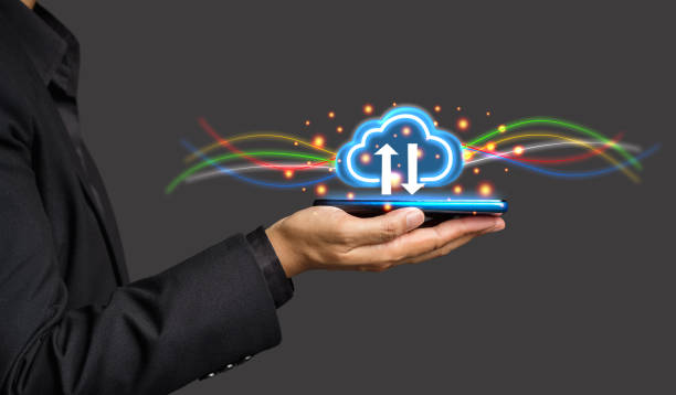 istock Businessman hand holding virtual cloud computing icon in the palm while standing on a gray background 1611712696