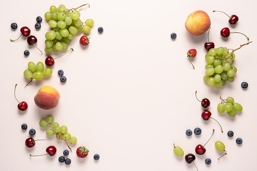 Mixed arrangement of fruit and vegetable on white background.