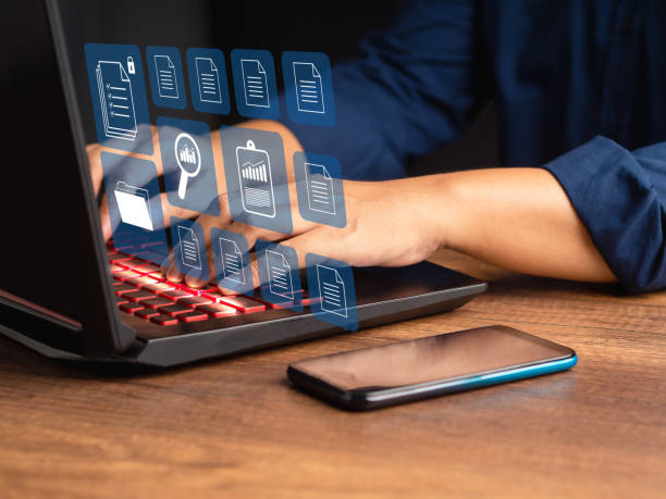 istock Businessman working at a laptop and digital documents on a virtual screen 1611720285