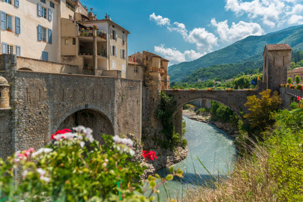 istock Picturesque old town on the river with arch stone bridge 1611738571
