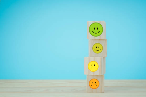 istock customer service concept Global Best Business Scoring Experience Satisfaction Survey Concept Businessman's hand selects a smiley face on a wooden block. 5 star satisfaction 1611767267