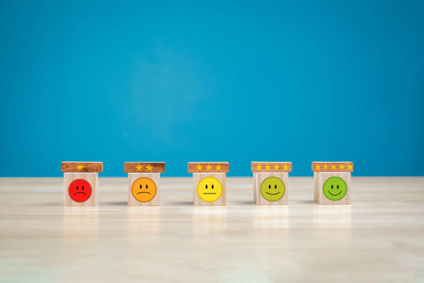istock customer service concept Global Best Business Scoring Experience Satisfaction Survey Concept Businessman's hand selects a smiley face on a wooden block. 5 star satisfaction 1611767268