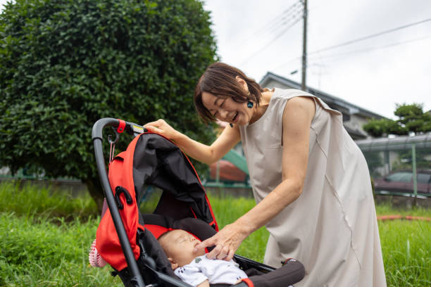 istock Grandmother putting her grandson in the stroller 1611806838