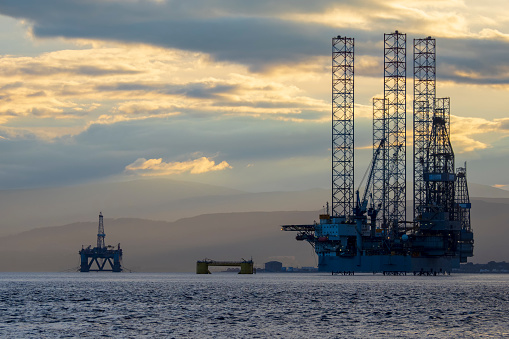 Oil rigs awaiting decomissioning, moored in the shallow waters of the Cromarty Firth in Scotland.