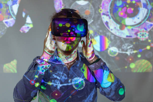 Machine Learning Young professor showing his students how to properly use VR glasses teacher projector stock pictures, royalty-free photos & images