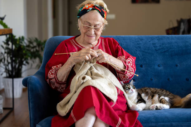istock Senior woman knitting on the sofa. 1611831249