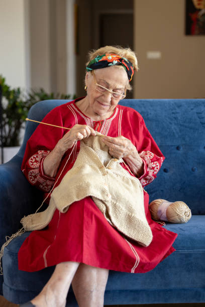 istock Senior woman knitting on the sofa. 1611832710